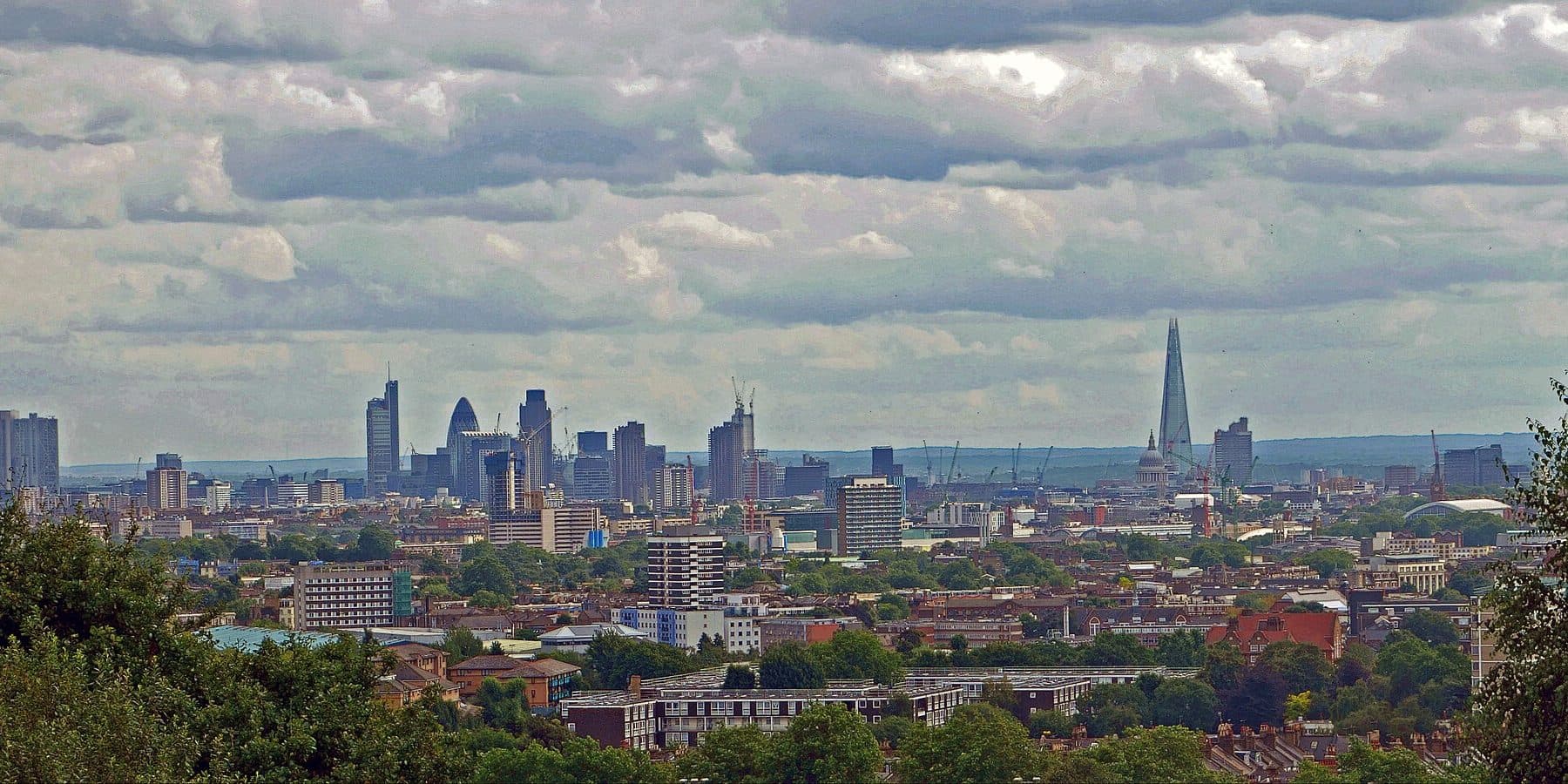 The London skyline above a foreground of trees and rooftops